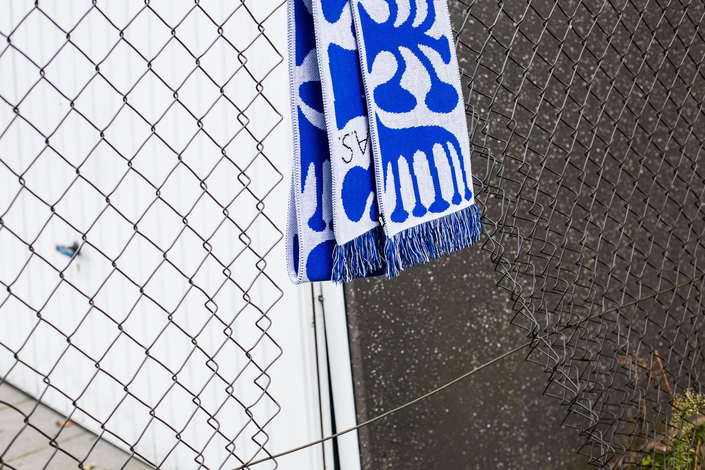 A League Extraordinaire scarf on a fence, 2019